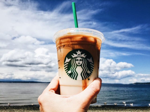 Finger, Drinkware, Drink, Coastal and oceanic landforms, Drinking straw, Coffee, Cup, Ocean, Shore, Coffee milk, 