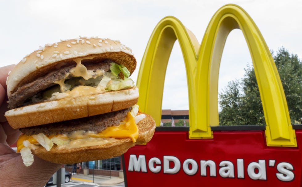 A McDonald's Big Mac, their signature sandwich is held up near the golden arches at a McDonalds's August 10, 2015, in Centreville, Virginia.      AFP PHOTO/PAUL J. RICHARDS        (Photo credit should read PAUL J. RICHARDS/AFP/Getty Images)