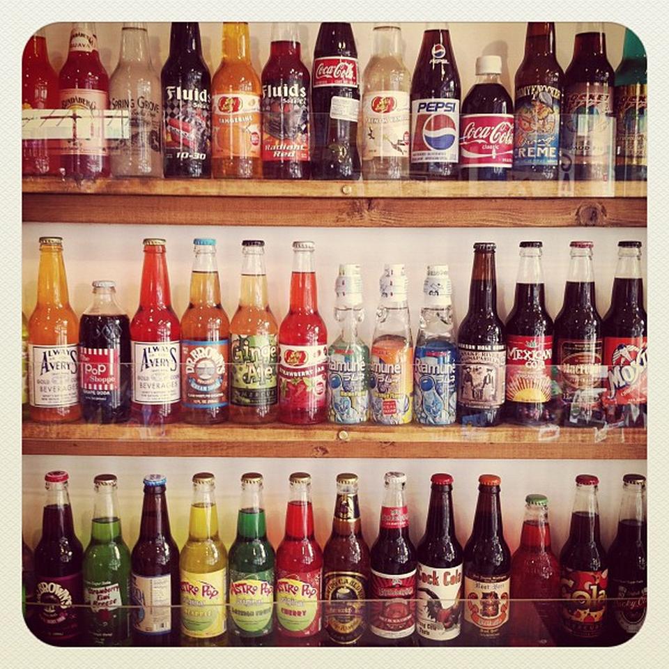 Drink, Bottle, Glass bottle, Red, Liquid, Logo, Alcohol, Carbonated soft drinks, Font, Drinkware, 