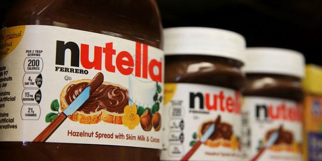 Bottle, Ingredient, Logo, Drink, Glass bottle, Condiment, Chocolate, Label, Packaging and labeling, Paste, 