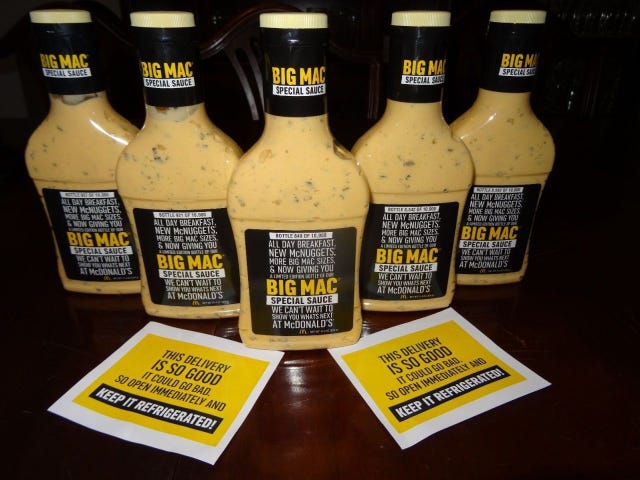 Yellow, Bottle, Liquid, Logo, Ingredient, Condiment, Bottle cap, Label, Glass bottle, Brand, 