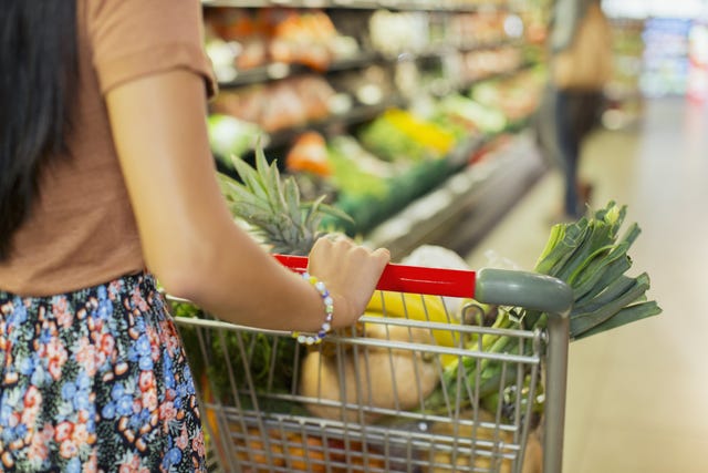 woman pushing cart at grocery store