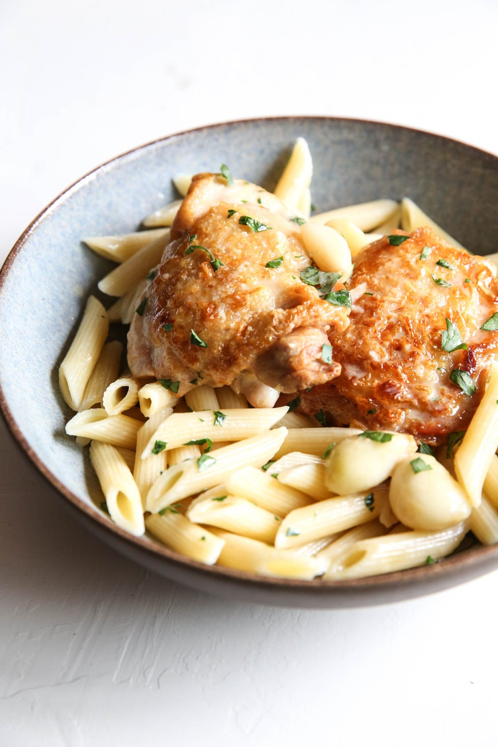 forty cloves of garlic chicken over penne vertical