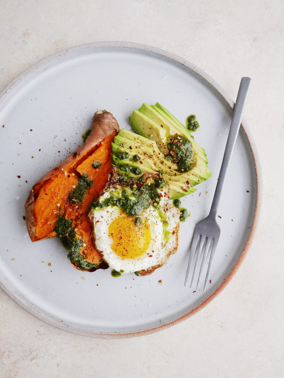 loaded baked sweet potatoes with avocado pesto and fried eggs
