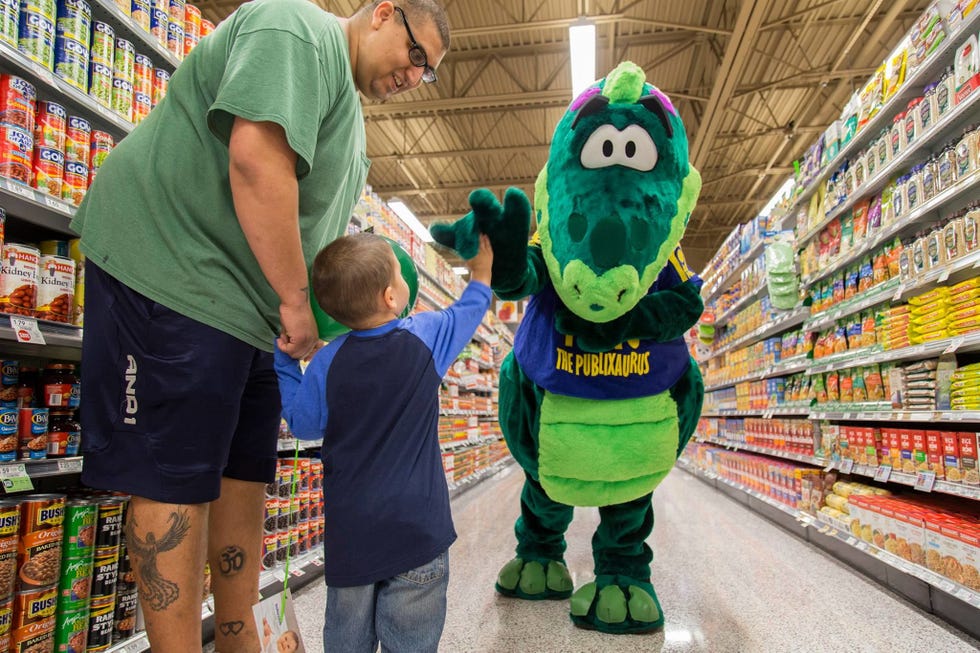 Supermarket, Green, Mascot, Grocery store, Fun, Retail, Animation, Building, Fictional character, Toy, 