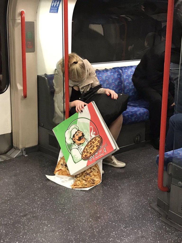 Photo of Drunk Girl Passed Out In London Tube With Box Of Pizza Goes Viral