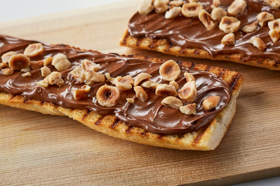 Warm demi baguette, served with Nutella and toasted hazelnuts