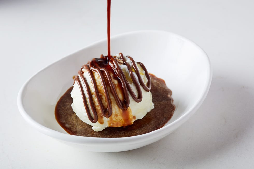 An affogato with fior di latte gelato, drizzled with Nutella and served with a warm espresso shot