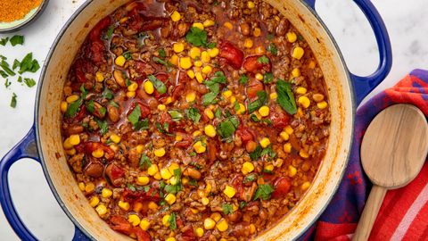 a pot of taco soup filled with ground beef, onions, tomato, beans and corn