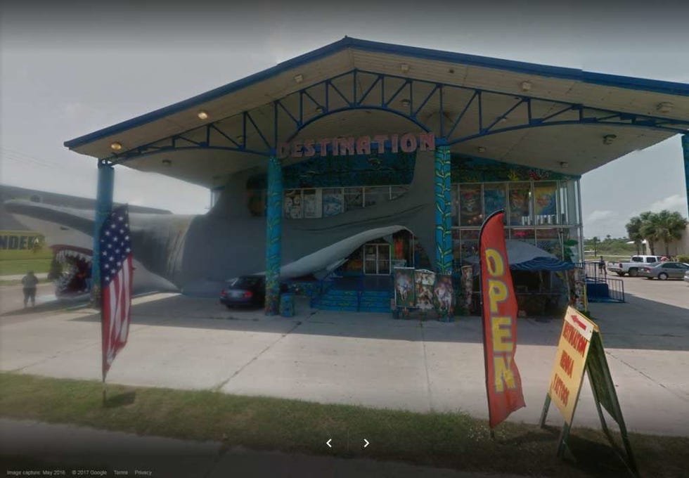 Flag, Asphalt, Shade, Pole, Gas, Filling station, Flag of the united states, Concrete, Lane, Gas pump, 