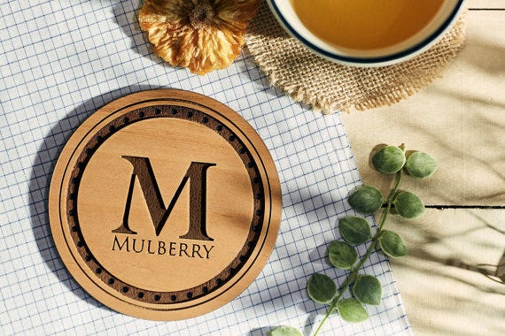 Placemat, Font, Coffee cup, Leaf, Textile, Cup, Tablecloth, Linens, Embroidery, Tea, 