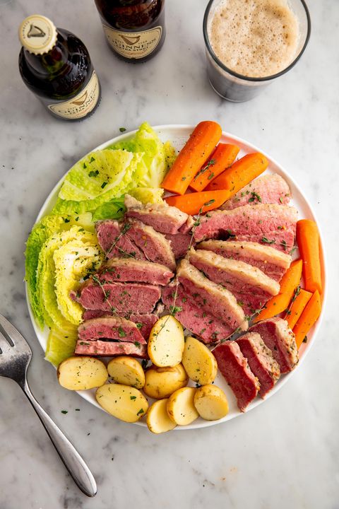 corned beef and cabbage plated with boiled potatoes and carrots