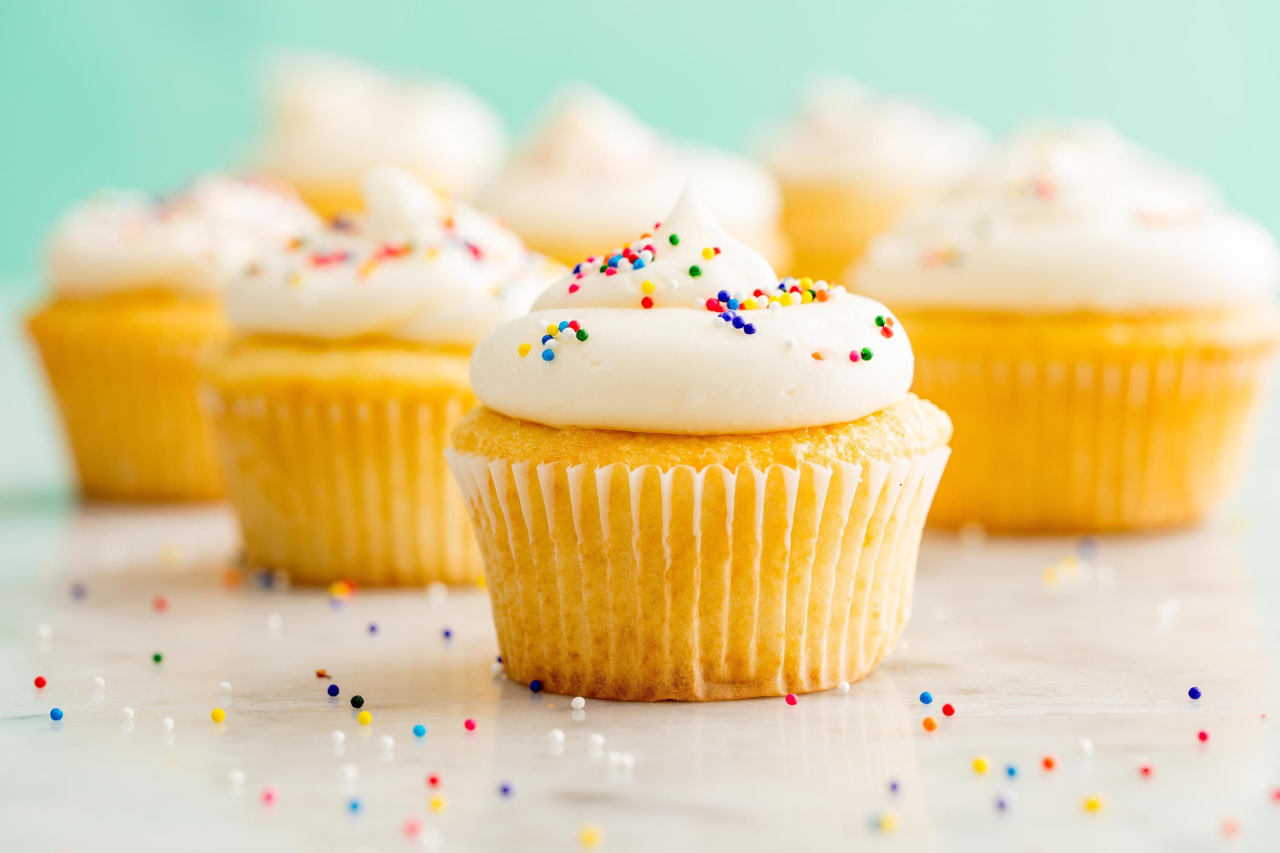 Vanilla Cupcakes With Pink Yellow And Blue Icing Isolated Stock Photo -  Download Image Now - iStock