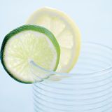 <p>Cut a slit in a slice of lemon or lime (or both together) and place on the rim of a glass; for larger fruit, such as orange or blood orange, use half-slices, slit from the center.</p>