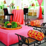 Think chiavari chairs and round tables are your only option? Think again. Work with your caterer and planner to develop an innovative seating arrangement that sets the right tone and matches your meal. (Just think about how different it would be to eat barbecue at a fancy restaurant versus your favorite outdoor rib joint.) Rent lounge chairs or low couches to go with passed hors d'oeuvres, or pair picnic tables with food stations for a rustic outdoor wedding. If you're serving food family-style, where guests help themselves, consider seating them at a mix of long and short tables for an intimate and relaxed feel.