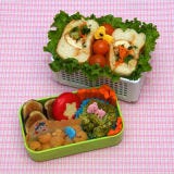 Banh mi in a basket turns to fruit, veggies, and a decorated Babybel cheese for support.