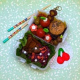 A mini portobello mushroom slider nestles among cherry tomatoes and olive skewers.