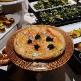 Smoked salmon pizza, a famous dish from the menu at Spago, Wolfgang Puck's flagship restaurant, will be served on Sunday night.