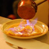 Among the showy desserts of the 1960s, crêpe suzette takes the cake: a sauce of butter, orange, and Grand Marnier is set aflame and poured over a crepe.