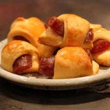 Cocktail foods became popular in the 1960s to support the decade's cocktail culture. Pigs in a blanket was an easy hors d'oeuvre made with pastry dough wrapped around cocktail sausages (or hot dogs).