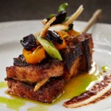 Del Campo, Washington, D.C. <p><strong>Smoke</strong>—that's what hits you first. The aroma of sweet smoke coming off everything from skirt steak and sweetbreads to charred beets, mortadella, and cheese sizzling on a grill the size of an airstrip. That smoke underpins most of Peruvian chef Victor Albisu's phenomenal cooking at Del Campo, a grand South American restaurant in D. C.'s Chinatown.</p>
<p>Albisu, whose grandfather was a Cuban baker and whose mother ran a market where her son learned to grill from Argentinean and Uruguayan butchers, has created a menu on which everything tastes as if it were prepared because you came to visit. Seafood and ceviches lashed with good olive oil share plates with chiles, charred onions, corn, yucca fries, romesco sauce, chimichurri, and <em>salsa criolla</em> (a tangy onion relish). The bar serves street food when the kitchen closes—empanadas, <em>albondigas</em> (plump, juicy meatballs), <em>chicharones</em> (fried pork), and <em>chivitos</em> (sandwiches stuffed with seared rib eye, mortadella, ham, cheese, olives, hearts of palm, and fried egg).</p>
<p>But the heart of the matter is a platter piled high with chorizo, short ribs, rib eye, lamb shank, and pork belly, all of them gleaming, fat-rich, and deep red, rosy, or pink, but always charred black. If the Peruvian food trend in the U. S.—which has been about to become a trend for a couple years now—needs a leader, Del Campo is it.</p>
<p><em>777 I Street NW; 202-289-7377; <a href="http://www.delcampodc.com/" target="_blank">delcampodc.com</a></em></p>