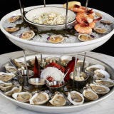 <p><strong>Every ten years,</strong> without fail, Mike Lata opens a new restaurant. The man is patient, never rushing off to New York or Vegas—not even Hilton Head—to stamp out some imitation of himself. And so, a decade after opening Fig—still one of the best restaurants on the Eastern Seaboard—he has unleashed the Ordinary, whose name belies the canny intelligence that went into making it a bellwether American seafood house built within the stately lineaments of a historic bank building, with sixteen-foot Palladian-arch windows and a backlit skylight. It's a big, echoing room with a fine long bar, a six-seat marble raw bar, and a lofty mezzanine overlooking the dining room.</p>

<p>Lata is a master of the trick of making the simple into small marvels of invention. You could, of course, just share tiers of iced shellfish lavished with peel-and-eat shrimp, clams, mussels, and lobster. And you would be happy. But you don't want to miss the fine-grained smoked-trout pâté with brown bread or the meaty skate wing with potato terrine and rémoulade sauce. One of the best main courses I had, which depend on what's best in the market that morning, was a southern triggerfish done ingeniously as a crisp schnitzel, with a simple brown-butter vinaigrette.</p>

<p>And for dessert, what else but a creamy, cool Carolina-gold-rice pudding? Wear seersucker or jeans—you'll find both here—and listen in on the lilting Daisy Buchanan–like drawl of women for whom local gossip is one of the high arts.</p>

<p><em>544 King Street; 843-414-7060; <a href="http://www.eattheordinary.com/" target="_blank">eattheordinary.com</a></em></p>