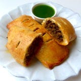 <p>Who said your pies have to always be sweet?</p>
<p><em>For Filling:</em><br />
1. In 12-inch skillet, heat 1 tablespoon oil on medium heat.<br />
2. Add 1 pound ground beef; 1 medium onion, finely chopped; 3 cloves garlic, finely chopped; 1 teaspoon chili powder; 1/4 teaspoon ground cinnamon; and 1 1/2 teaspoon salt. <br />
3. Cook 8 to 10 minutes or until onions are starting to soften and beef is cooked, breaking up meat with back of spoon. <br />
4. Remove from heat and stir in 3 tablespoons fresh cilantro, finely chopped. Let cool.</p>
<p><em>For Pies:</em><br />
1. Preheat oven to 400 degrees F. Roll and stretch a handful of dough into rough 9-inch by 9-inch square.<br />
2. Add scant 1/2 cup of filling to one side of dough in rectangular pile. Fold other side of dough over, pinching to seal. With pizza cutter, cut sealed edges to form 8-inch by 4-inch rectangle. Place on parchment-lined cookie sheet. Repeat 3 more times for total of 4 pies.<br />
3. Brush tops with beaten egg yolk. Cut 5 slits in each pie to vent steam. Bake 15 to 20 minutes or until deep golden brown. Let cool 5 minutes. before serving with salsa verde or jalapeño hot sauce.</p>