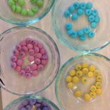 <p>Organize your candy into little bowls by color. This will make decorating the cake much easier.</p>