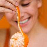 Woman Peeling Orange