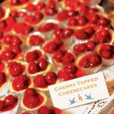 Nothing says summer quite like cherry <a href="/recipes/cooking-recipes/easy-cheesecake-clv1010">cheescake</a>, and these bite-size treats are just the thing. Cheesecake cups displayed on a doily are the perfect complement to an intimate down-home reception.