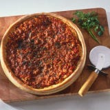 <p>The Chicago-style "deep-dish" pizza was in 1943 at Chicago's Pizzeria Uno. It was reportedly invented by Uno's founder, Ike Sewell, a former University of Texas football star. But a 1956 article from the Chicago Daily News asserts that Uno's original pizza chef, Rudy Malnati, developed the recipe. Either way, Chicago is the undisputed birthplace of the deep-dish wonder, which will always pay homage to its home with its name.</p><br />
<p><b>Try These Homemade Recipes: </b><br />
<a href="/recipefinder/chicago-deep-dish-pizza-recipe-clt0111"><b>Chicago Deep-Dish Pizza</b></a><br />
<a href="/recipefinder/chicago-deep-dish-style-veggie-pizza-recipe"><b>Chicago Deep-Dish-Style Veggie Pizza</b></a><br />
<a href="/recipefinder/deep-dish-pizza-dough-3835"><b>Deep-Dish Pizza Dough</b></a></p>