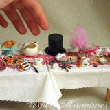 <b>The Artist:</b> Veselina Koleva, <a href="http://vesperminiatures.blogspot.com/" target="_blank">Vesper Miniatures</a><br /><br />

If Alice ever finds herself shrinking again, at least she can enjoy a good feast — we just hope she likes clay. This impressive table was created by Veselina Koleva, who works in a 1:12 scale and often gets inspired by fairy tales and books.