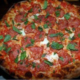 <p><b>Signature Item</b>: Apizza Amore (with tomato sauce, both fresh and aged mozzarella, pecorino, grana, olive oil, cured pork shoulder and fresh basil).<br />

Pizzaiolos Brian Spangler, Dan Roberts and Jon Ullrich are so exacting about their craft that they mix their dough by hand daily and won't let customers put any more than three toppings on the nicely charred pies. <a href="http://www.apizzascholls.com" target="_blank">apizzascholls.com</a>.</p>