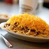 <p>A spice blend that includes cinnamon and cloves and the unusual practice of serving over spaghetti differentiates Cincinnati chili from the rest of its American variants. Most chili historians cite a number of Cincinnati restaurateurs who emigrated from Greece and Macedonia as the originators of this fragrant, bean-less stew, which customers order by specifying the number of "ways", or additions, they'd like with their bowl of chili. 3-Way is the basic order which consists of a mound of spaghetti topped with ground-beef chili and shredded Cheddar cheese. If you're hungry for the works, go for a 5-Way which also includes diced onions and red beans. Like other venerable chili parlors in the Queen City, Camp Washington Chili dishes up their secret-recipe chili in a bowl, on hot dogs (called Coney Dogs), in a steamed bun sandwich with cheese, and over French fries.</p><br /><p><i>3005 Colerain Ave, Cincinnati, Ohio; (513) 541-0061; <a href="http://www.campwashingtonchili.com/index.cfm" target="_blank">campwashingtonchili.com</a></i></p>