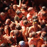 <p>What began as an altercation between a parade go-er and a group of teenagers shortly after 1945 has since grown into a full-on public tomato war. Every year on the last Wednesday in August in Buñol, Spain, more than 30,000 people gather for the annual Tomatina. As truck loads equal to 100 metric tons (or 2,205 pounds) of squishy, ripe tomatoes are hauled in for the friendly battle, the town prepares — streets are shut down, the windows are covered with plastic, and people strip off their shirts. But the tomato tossing can't begin until someone has retrieved the ham, which is perched atop a well-greased pole. Once down, a cannon fires to signify the official start. The rules? Tomatoes must be squished before they are thrown and participants are advised to wear protective goggles. After two hours the battle ends and everyone is hosed off.</p>