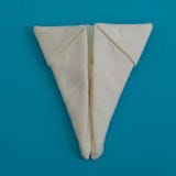 Fold the bottom point up, so that it is roughly 1" above the center of the napkin.