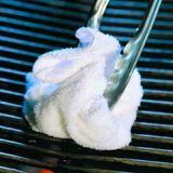 Use a tightly folded paper towel dipped in vegetable oil or a chunk of bacon fat held at the end of your tongs to oil the grate before you put on the food. Or do as Israeli grill masters do: Impale half an onion on the end of a barbecue fork. Dip the onion in oil and rub it across the bars of the grate.