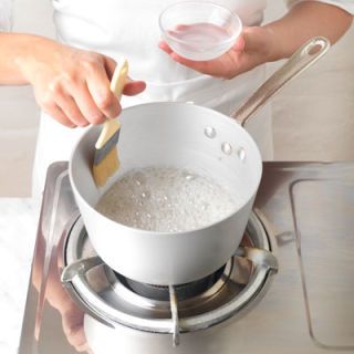 <p>All the sugar needs to be dissolved when you're making caramel. Some sugar will stick to the sides of the pan — brush these off using a dampened pastry brush.</p>