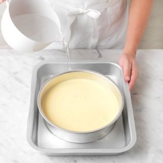 <p>Put the custard into a baking dish and pour enough boiling water around the cake pan to come halfway up its side.</p>