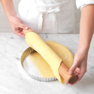 <p>Use a rolling pin to gently ease the pastry into the tart pan, being careful not to stretch it.</p>