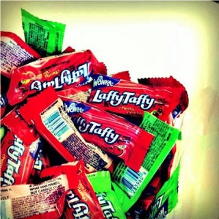 <p>Why did the chicken cross the road? To get to the Laffy Taffy! Laffy Taffys were actually introduced by the Willy Wonka Candy Company in the 1970s, but we all gobbled them down like, well, candy in the 90s. These individually wrapped, chewy, tongue-stainingly colorful taffys had jokes written on the wrappers, written by taffy-consuming child pun prodigies. Although Laffy Taffys are still on the market, but they don't make 'em like they used to -  literally, because the candies used to be short and fat, and now they're longer and flatter, and sometimes have sparkles.</p>