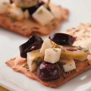<p>Olives and feta marinated with rosemary, lemon, and garlic are great served on crisp flatbread-style crackers or warm slices of crusty baguette.</p><br /><p><b>Recipe:</b> <a href="/recipefinder/marinated-olives-feta-recipe-ew1110" target="_blank"><b>Marinated Olives and Feta</b></a></p>