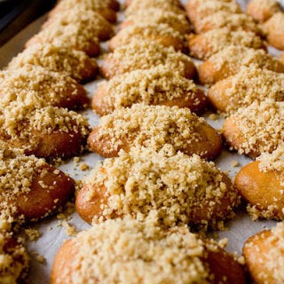 Greece: Melomakarona <p>Christmas is major affair in Greece, and there are many ways in which people celebrate. Many religious Greeks fast before Christmas, as in other countries throughout Europe, so when feast day finally arrives, it's a time to go all out. One traditional sweet that still has a place at many festive holiday tables is <i>melomakarona</i>, a sweet, honey-soaked cookie topped with ground walnuts and eaten on Christmas Day after breaking fast.</p>