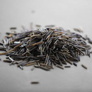 Not a member of the rice family at all but the seed of an aquatic grass native to the cold regions of North America. Wild rice has a strong nutty taste and can be expensive, so it is best used combined with brown and white rices in pilafs, stuffings and salads.