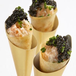 Wolfgang Puck created smoked salmon "pizza" cones topped with caviar and chives as part of a collection of tray-passed hors d'oeuvres.