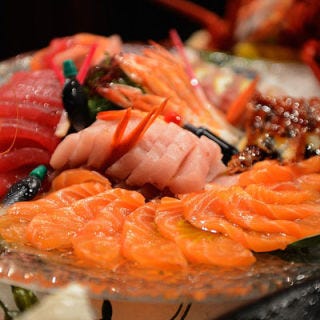 Raw fish aficionados will dine on slices of uncooked tuna, salmon, and eel sashimi.