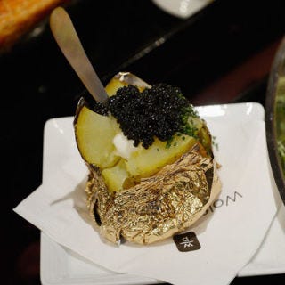 Forget cheddar and chives — Wolfgang Puck's baked potato is smothered in caviar.