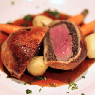 Roger Sterling revels over a hotel's room-service beef Wellington, and if done well, the meal truly is an indulgent treat: a filet coated with pâté, then encased in puff pastry and baked.