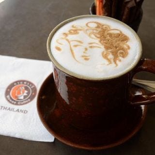 <p>Perhaps the most impressive element of this latte etching is the detail in the woman's curly hair. We're hoping this is a portrait of the early morning coffee shop goer, but guessing it probably isn't.</p>
<p>Spotted at <a href="http://www.waweecoffee.com" target="_blank">Wawee Coffee</a> in Chiang Mai, Thailand.</p>
