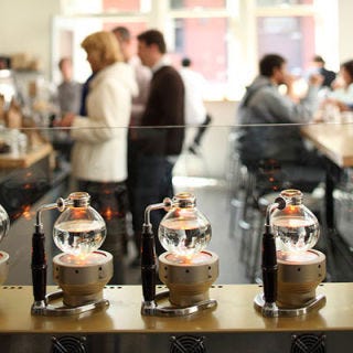 Blue Bottle; Oakland, CA Now with 11 locations between the Bay Area and New York, Blue Bottle has become a household name in boutique coffee brands with small batches of organic beans roasted in vintage machines. Freshness is a mantra here—all beans not sold within 48 hours of roasting are put into service—as either drip or iced coffee. At the Webster Street facilities, baristas pull shots of single-origin coffees from an impressive La Marzocco Strada espresso machine, while pour-overs feature single-origin roasts and one blended coffee. Unique in-house sweets include such experiments as saffron snickerdoodles and savory shortbread with Parmesan and fennel.<a href="http://www.bluebottlecoffee.net" target="_blank">bluebottlecoffee.net</a>